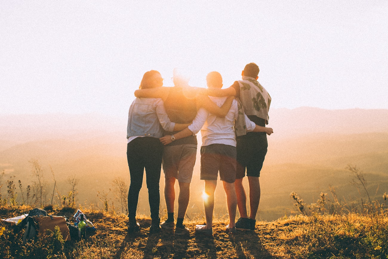 Students from different backgrounds standing together outdoors